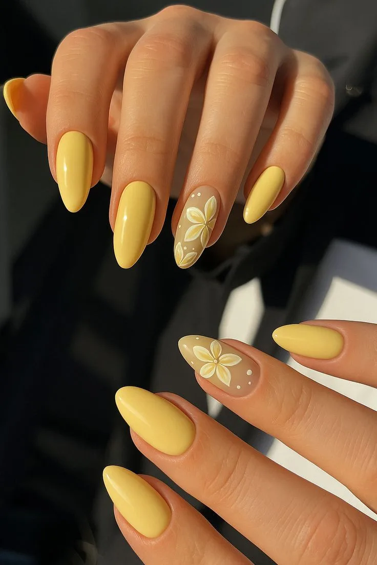 Yellow almond nails with delicate floral artwork