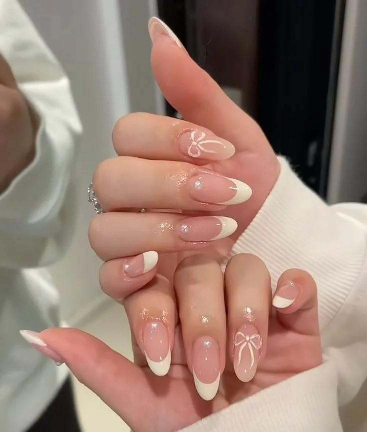 Nude almond nails with fine white floral artwork
